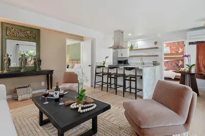 a living room with a table and chairs and a kitchen at Private Garden and Family Friendly in Summerland