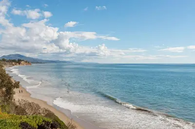 a view of a beach with people walking on it at Jasmine Hideaway and Newly Renovated in Summerland