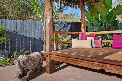 a wooden bench sitting on a patio at Jasmine Hideaway and Newly Renovated in Summerland