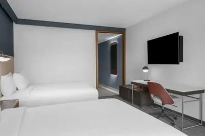 a hotel room with two beds and a desk at Courtyard by Marriott San Bernardino Loma Linda in Loma Linda