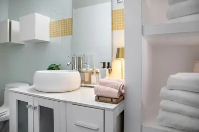 a bathroom with a sink and towels on a counter at Stylish loft 2 queens & 2 sofas in Los Angeles