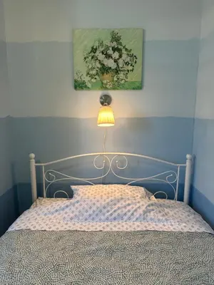 a bedroom with a bed with a lamp and a painting at Nice Room Near Citrus College in Glendora