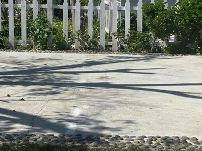 a white picket fence and a sidewalk with rocks at Nice Room Near Citrus College in Glendora