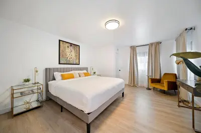 a bedroom with a bed and a desk and a chair at Hidden South Bay Gem near Manhattan and Redondo Beach in Redondo Beach