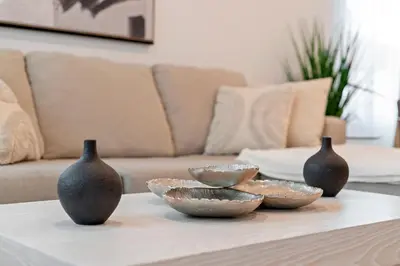 three vases sitting on a coffee table in a living room at Hidden South Bay Gem near Manhattan and Redondo Beach in Redondo Beach