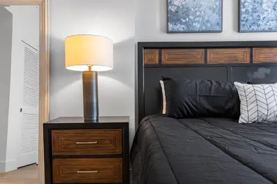 a bedroom with a bed and a lamp on a nightstand at 12 Best Location Cozy Apartment in Los Angeles