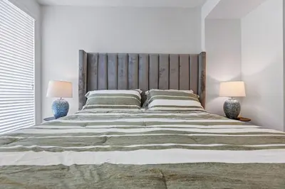 a bedroom with a large bed with two lamps at 12 Best Location Cozy Apartment in Los Angeles