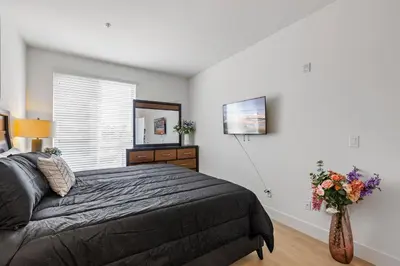 a bedroom with a bed and a vase of flowers at 12 Best Location Cozy Apartment in Los Angeles