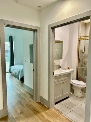 a bathroom with a sink and a toilet and a bed at Newly Gated Stylish Steps to Hollywood 2B2B in North Sherman Way
