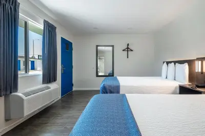 a hotel room with two beds and a window at La Casita Inn in Wilmington