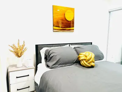 a bedroom with a bed with a yellow rope on it at Newly Built Stylish Modern 2B In LA in North Sherman Way