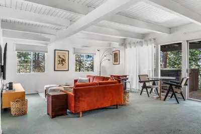 a living room with a couch and a table at Luxury A-Frame Retreat in Lake Arrowhead