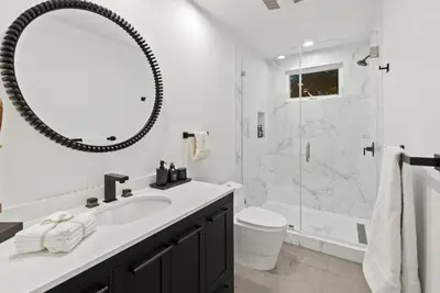 a white bathroom with a sink and a shower at Hollywood Hills 3 Bedroom Views and Jacuzzi in Los Angeles