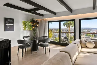 a living room with a couch and a table with chairs at Hollywood Hills 3 Bedroom Views and Jacuzzi in Los Angeles