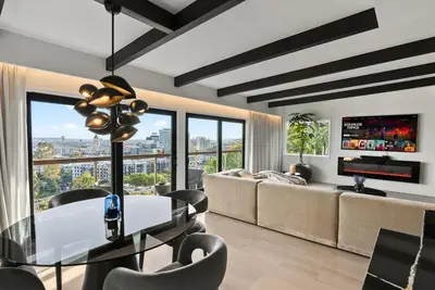 a living room with a glass table and a couch at Hollywood Hills 3 Bedroom Views and Jacuzzi in Los Angeles