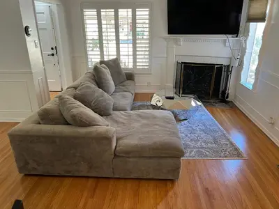 a living room with a large couch and a fireplace at Modern piano Los Angeles home by universal studio & Hollywood for 10 in Studio City