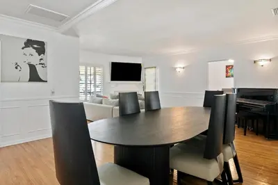 a dining room with a table and chairs and a piano at Modern piano Los Angeles home by universal studio & Hollywood for 10 in Studio City