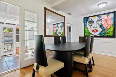 a dining room with a black table and chairs at Modern 4bed 3bath home with piano near Universal Studio & Hollywood for 10 in Studio City