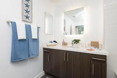 a bathroom with a sink and a mirror at Hollywood Cozy Apartment in Los Angeles