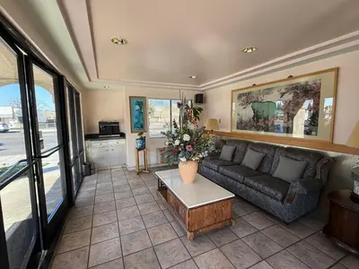 a living room with a couch and a table at Fiesta Inn Los Angeles - Bell Gardens in Bell Gardens