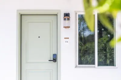 a white door with a light on it at The LEEF Hotel in Glendale