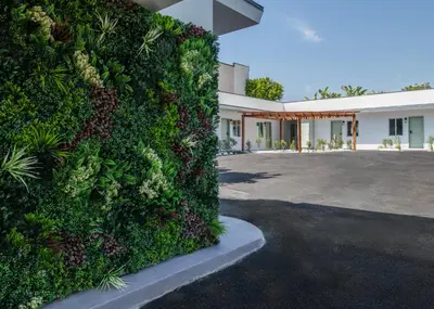 a green wall in front of a building at The LEEF Hotel in Glendale