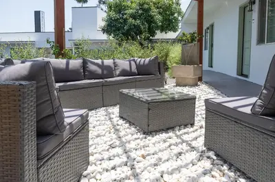 a patio with two couches and a table on rocks at The LEEF Hotel in Glendale