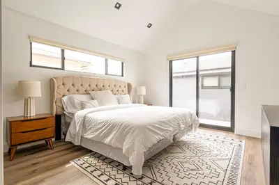 a white bedroom with a large bed and a window at Tulum Style in Sherman Oaks in Garnsey