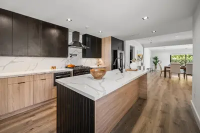 a kitchen with wooden cabinets and a white counter top at Tulum Style in Sherman Oaks in Garnsey