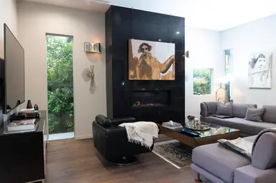 a living room with a couch and a fireplace at Luxury Living in West Hollywood Modern 3BR Home w Pool & Hot tub in Los Angeles