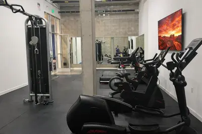 a gym with rows of exercise bikes in a room at Designer 1 Bedroom Condo in Prime Hollywood in Los Angeles