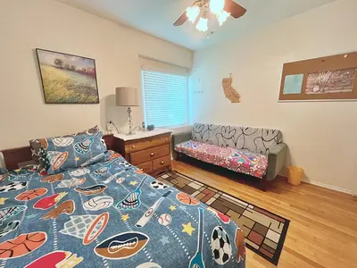 a bedroom with a bed and a bed and a couch at Cozy Beautiful Private Home in Prime Location in Glendora
