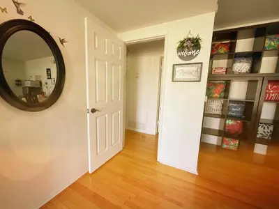 a hallway with a mirror and a white door at Cozy Beautiful Private Home in Prime Location in Glendora