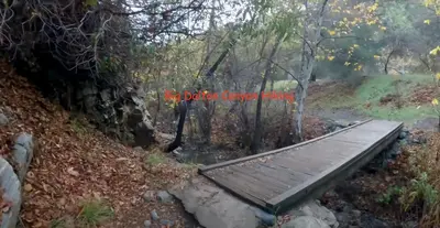 a wooden bench sitting on the side of a trail at Cozy Beautiful Private Home in Prime Location in Glendora