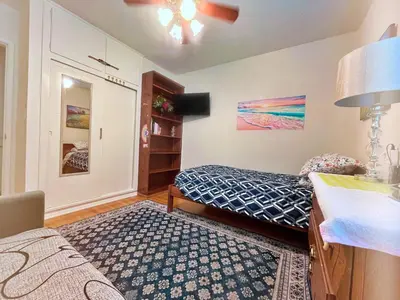 a bedroom with a bed and a table with a lamp at Cozy Beautiful Private Home in Prime Location in Glendora