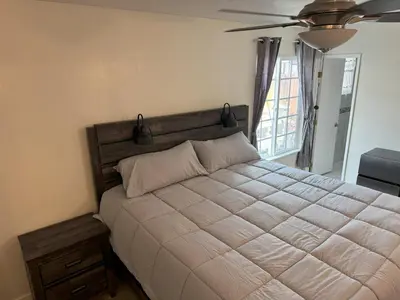 a bedroom with a large bed and a ceiling fan at King's Suite Escape in Ontario