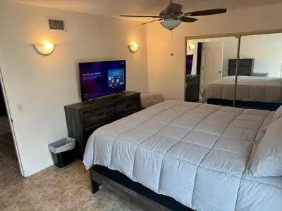 a bedroom with a bed and a flat screen tv at King's Suite Escape in Ontario