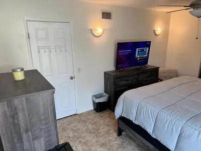 a bedroom with a bed and a flat screen tv at King's Suite Escape in Ontario