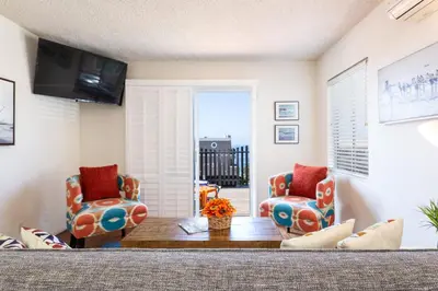 a living room with two chairs and a table at The Sea View Inn At The Beach in Manhattan Beach