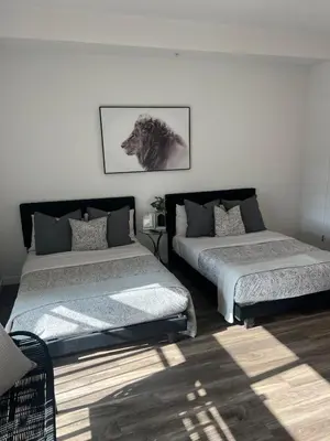a bedroom with two beds and a picture of a lion at The sunset loft apartment FREE parking in Los Angeles