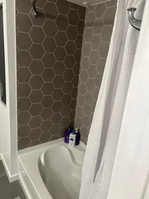 a white bath tub with a shower curtain in a bathroom at The sunset loft apartment FREE parking in Los Angeles