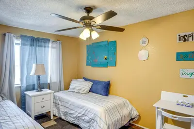 a bedroom with a bed and a ceiling fan at Patio and Mtn Views Family Gem in California City in California City