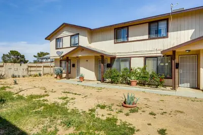 a house with a dirt yard in front of it at Patio and Mtn Views Family Gem in California City in California City