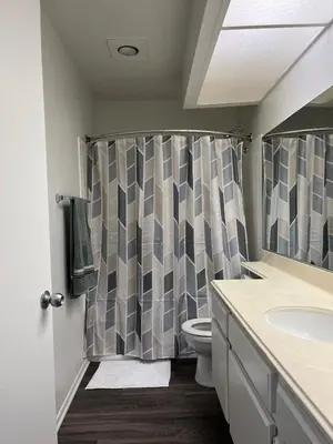 a bathroom with a shower curtain and a toilet at Starlight Studio near Sunset in Los Angeles