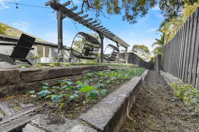 a garden with a swing and some plants at Malibu Beach House by Stay Awhile Villas in Malibu