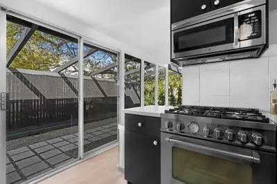 a kitchen with a stove and a microwave at Malibu Beach House by Stay Awhile Villas in Malibu