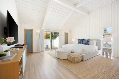 a white bedroom with a bed and a tv at Malibu Cove Colony Beach by Stay Awhile Villas in Malibu