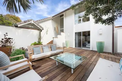 an outdoor patio with a glass table and benches at Malibu Cove Colony Beach by Stay Awhile Villas in Malibu
