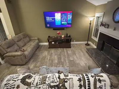 a living room with a couch and a flat screen tv at Riverside Views & Pool Retreat in Riverside