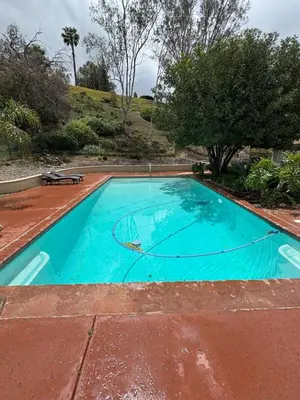 a large blue swimming pool on a red brick patio at Riverside Views & Pool Retreat in Riverside